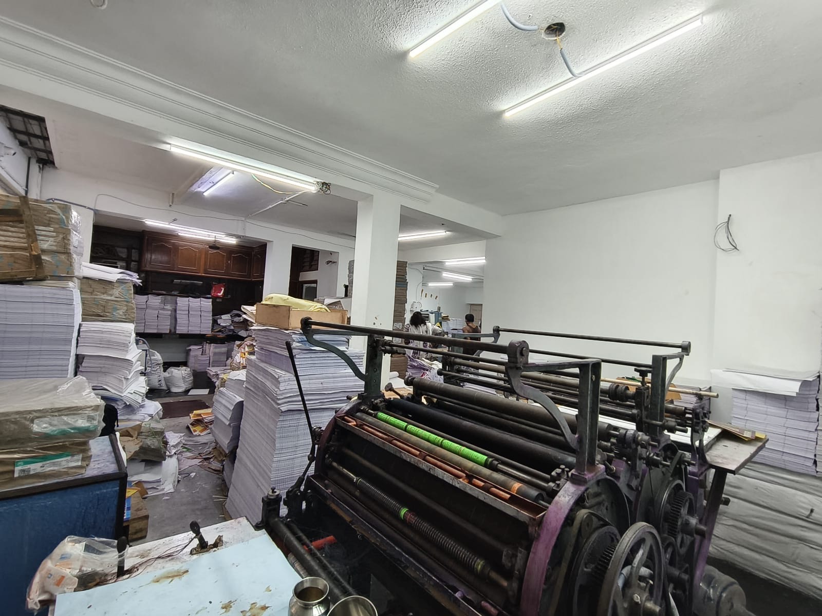 Production machinery surrounded by paper stock